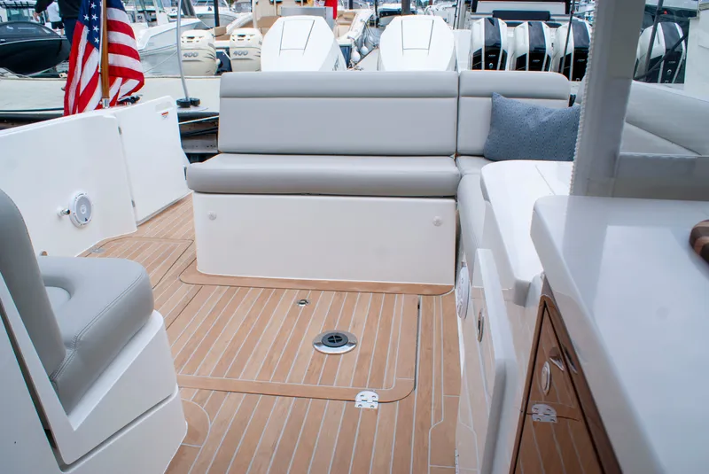 Slide: The Image of The image shows the cockpit of a 2027 MJM Yachts 38R with sleek seating and teak flooring. - 8