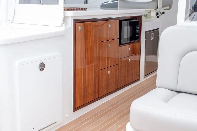 Slide: The Image of The 2027 MJM Yachts 38R features elegant interior with wooden cabinetry and modern appliances. - 16