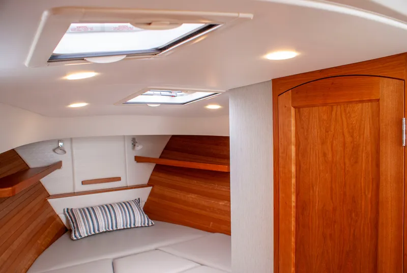 Slide: The Image of Interior of a 2027 MJM Yachts 38R with wooden doors and a cozy seating area. - 37