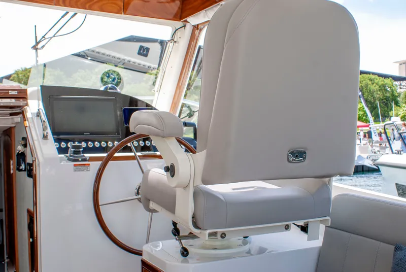 Slide: The Image of The image shows the cockpit of a 2027 MJM Yachts 38R with a sleek steering wheel and modern navigation system. - 29