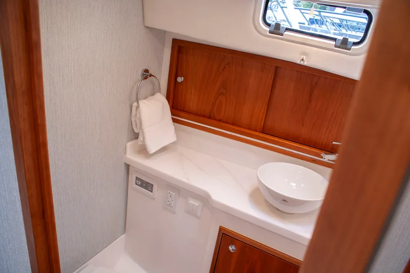 Slide: The Image of The image shows an elegant yacht bathroom with wood paneling and a modern sink. - 40