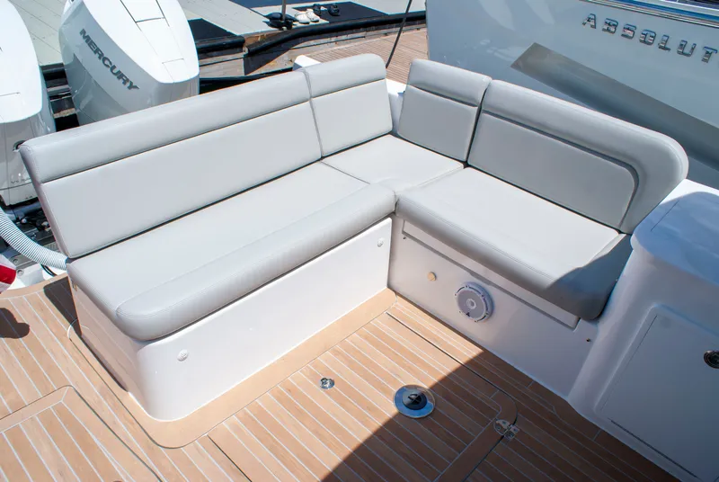 Slide: The Image of MJM Yachts 38R 2027: Elegant gray upholstery on an L-shaped outdoor seating area. - 6