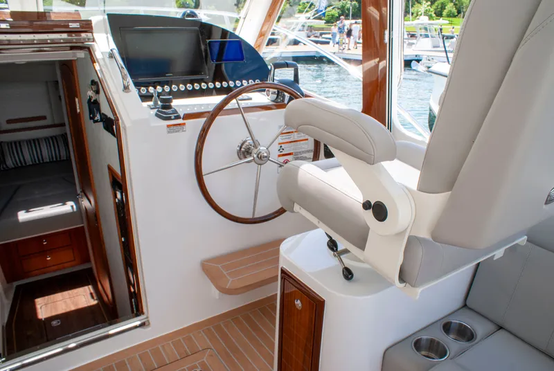 Slide: The Image of The cockpit of the 2027 MJM Yachts 38R features a sleek steering wheel and modern instruments. - 20
