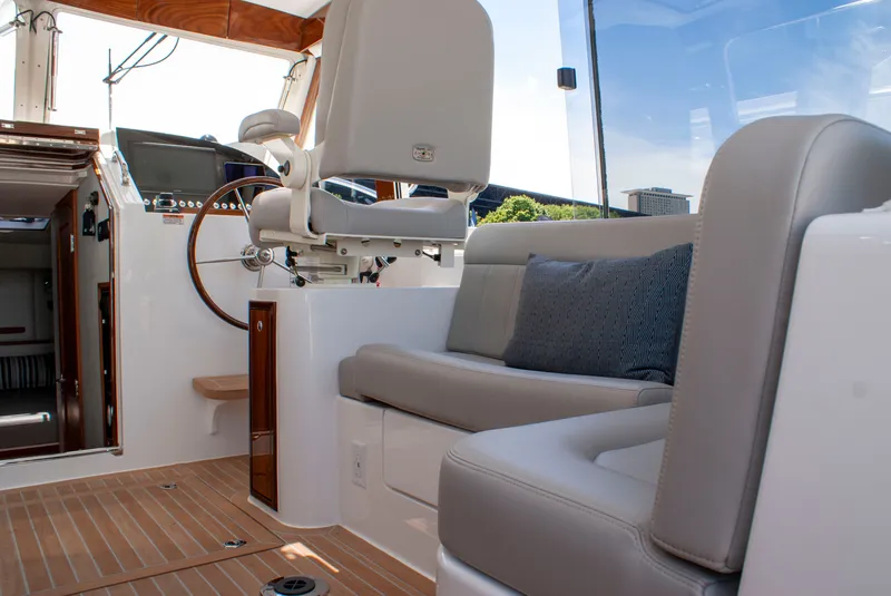 Slide: The Image of The image shows the cockpit of a 2027 MJM Yachts 38R with sleek seating and a steering wheel. - 22