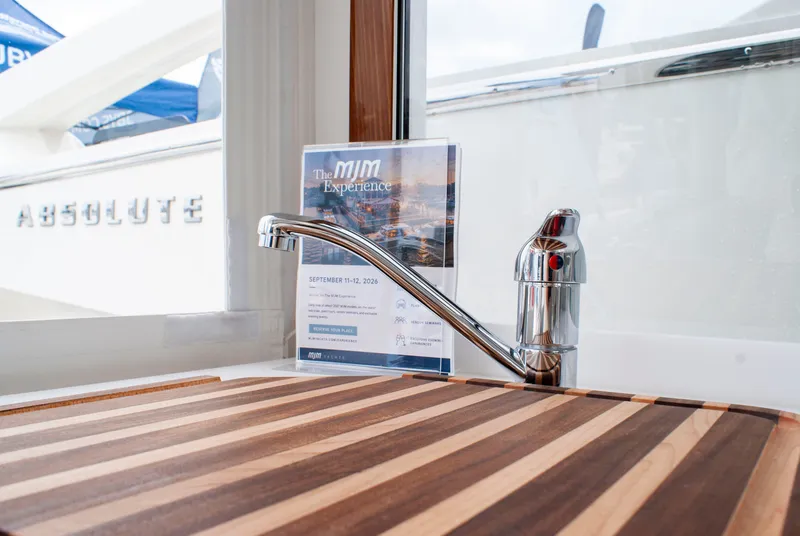 Slide: The Image of A sleek faucet and striped wooden board are visible in the galley of an MJM Yachts 38R. - 18