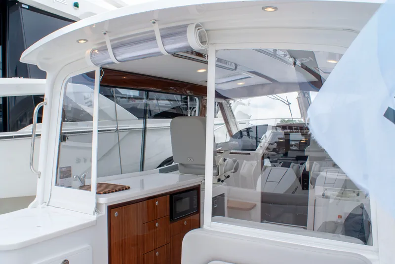 Slide: The Image of The image shows the cockpit of a 2027 MJM Yachts 38R with sleek wood accents and modern amenities. - 11