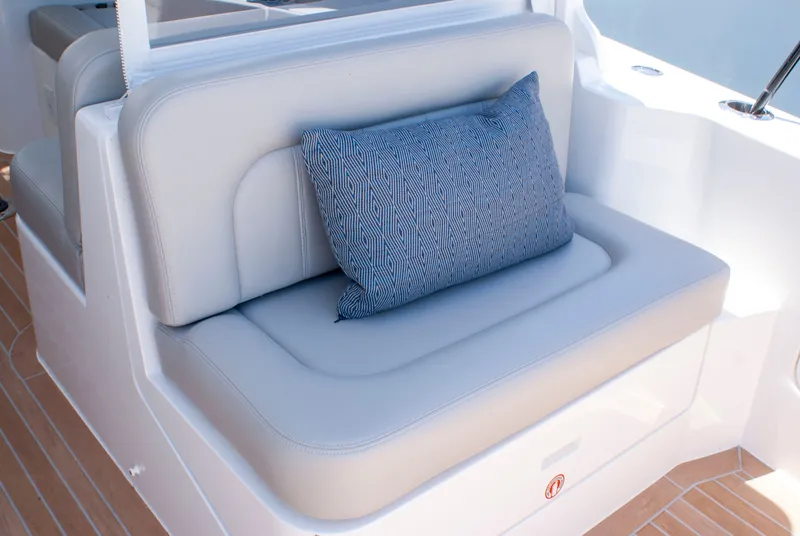 Slide: The Image of A sleek seating area with a blue cushion on a modern boat. - 5