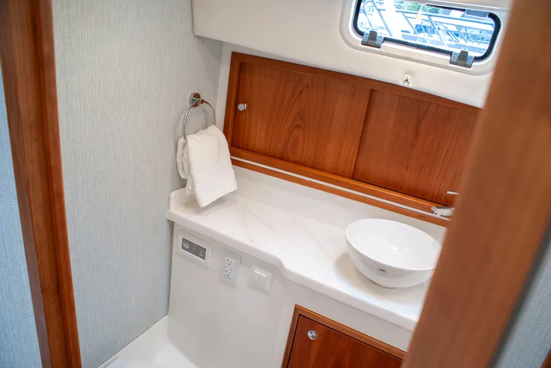 Slide: The Image of The image shows a yacht's elegant bathroom with wood paneling and a modern sink. - 41