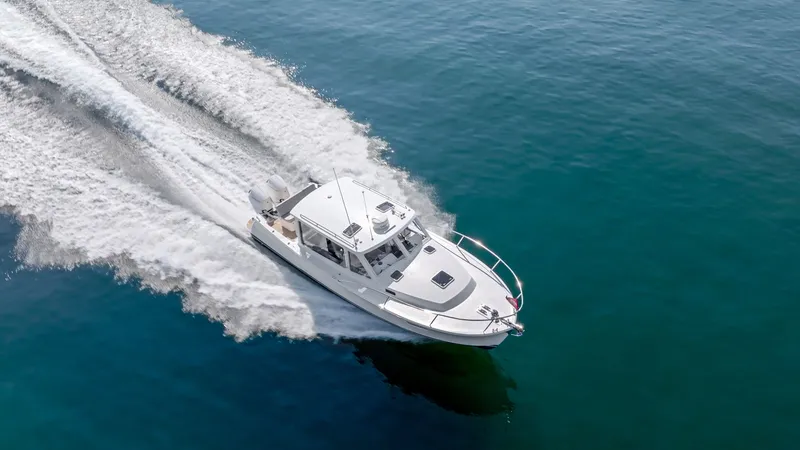 Slide: The Image of A sleek, modern motorboat speeds across calm, blue water, leaving a white wake behind. - 4