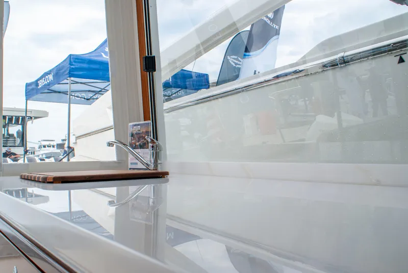 Slide: The Image of The 2027 MJM Yachts 38R features a sleek countertop with a faucet and cutting board. - 17
