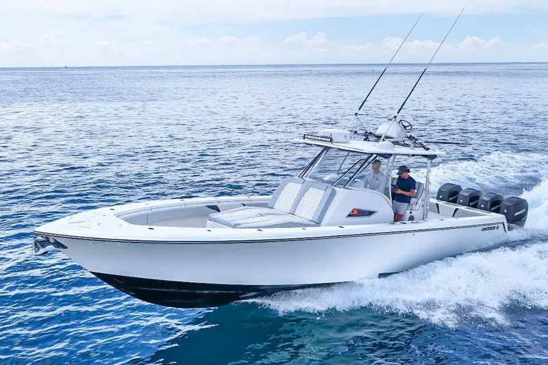 The Image of 2018 Contender 39 Fisharound boat cruising on open water, featuring multiple outboard engines. - 1