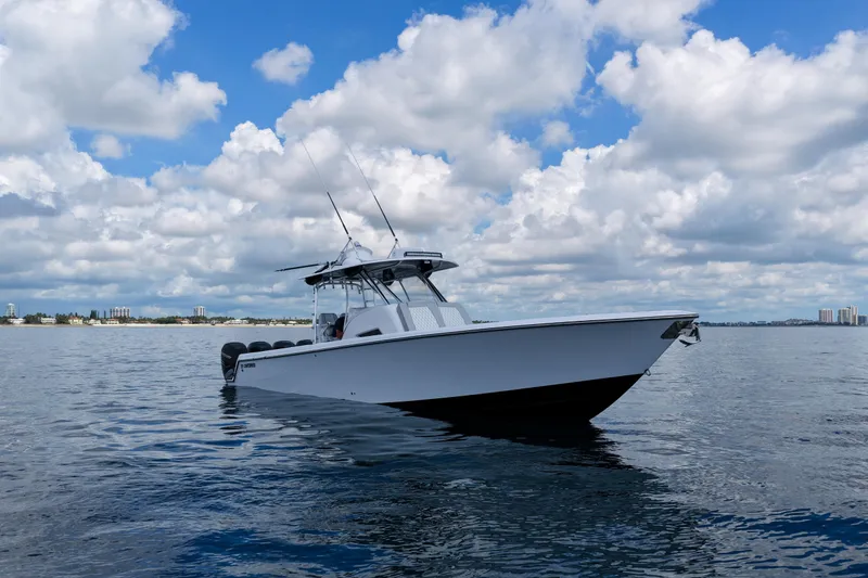 Slide: The Image of 2018 Contender 39 Fisharound boat on calm water under a cloudy sky. - 10