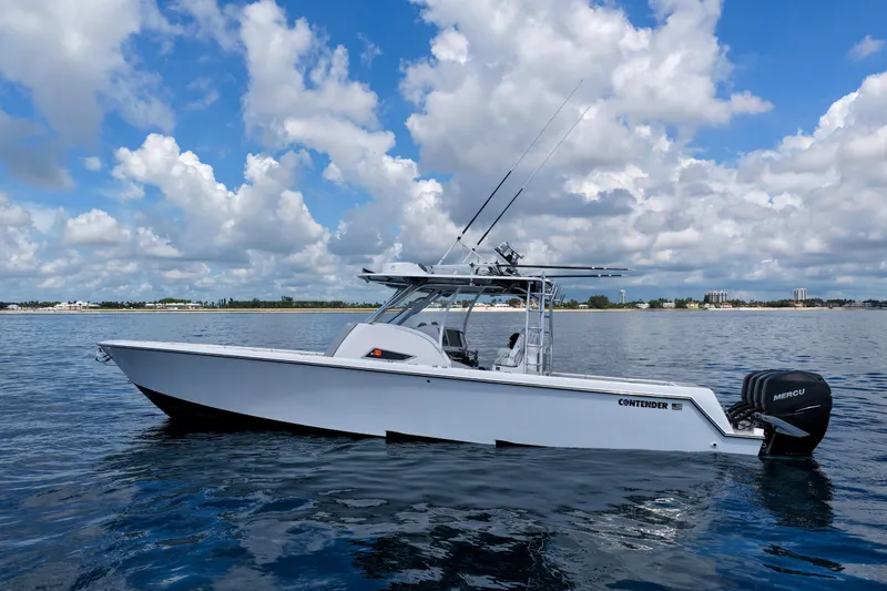 Slide: The Image of 2018 Contender 39 Fisharound boat on calm water under a partly cloudy sky. - 9