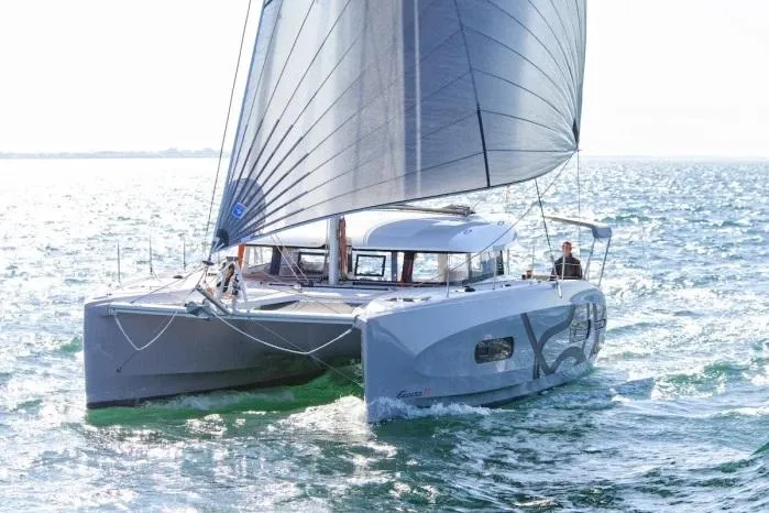Slide: The Image of Manufacturer Provided Image: Sailing catamaran Excess 11, 2026 model, gliding on open water with full sails. - 13