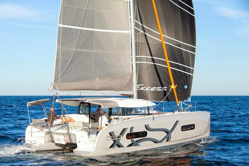 Slide: The Image of 2026 Excess 11 catamaran sailing on open sea with modern design and spacious deck. - 29