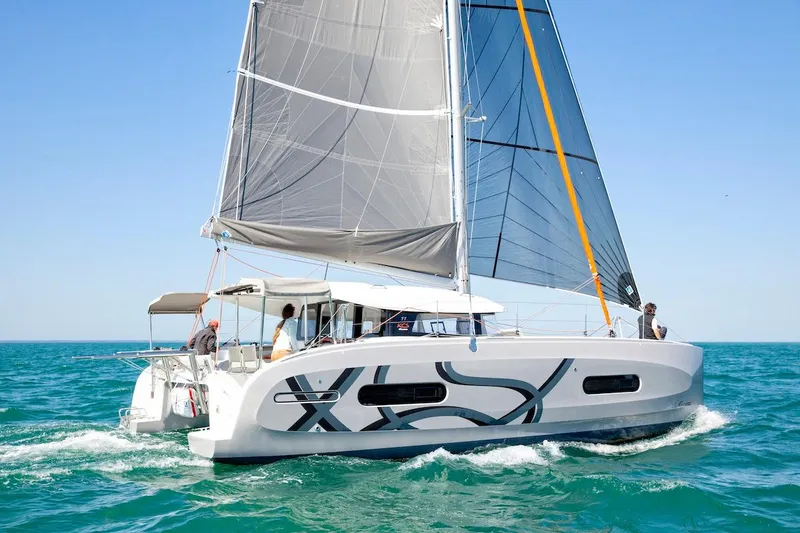Slide: The Image of Sailing catamaran Excess 11, 2026 model, cruising on clear blue ocean waters. - 30