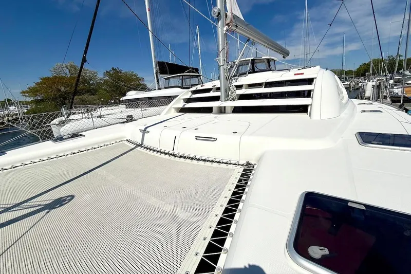 Slide: The Image of Sailing catamaran Leopard 46, 2010 model, docked at marina under clear blue sky. - 11