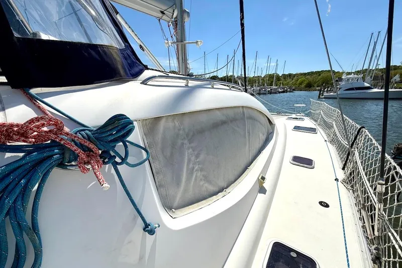 Slide: The Image of 2010 Leopard 46 yacht deck with ropes, docked in a marina under clear blue skies. - 19