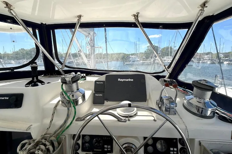 Slide: The Image of Cockpit view of a 2010 Leopard 46 yacht with navigation equipment and marina backdrop. - 24