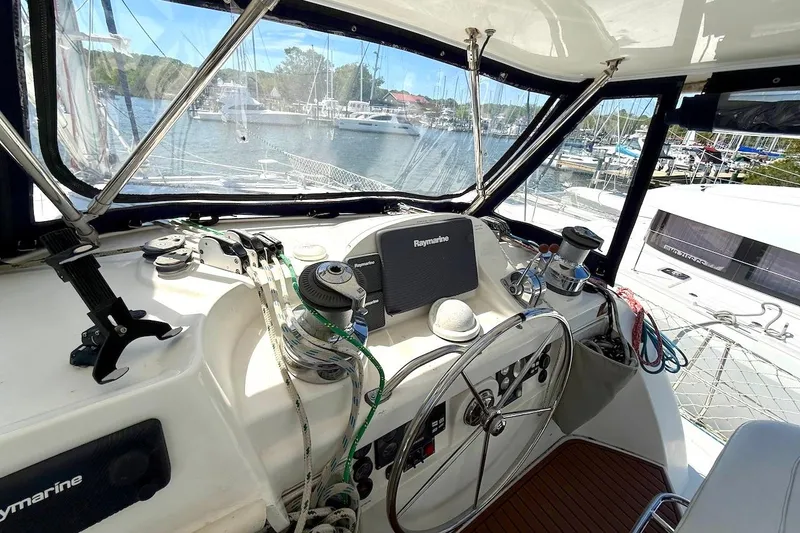 Slide: The Image of Helm of 2010 Leopard 46 yacht with navigation equipment and marina view. - 26