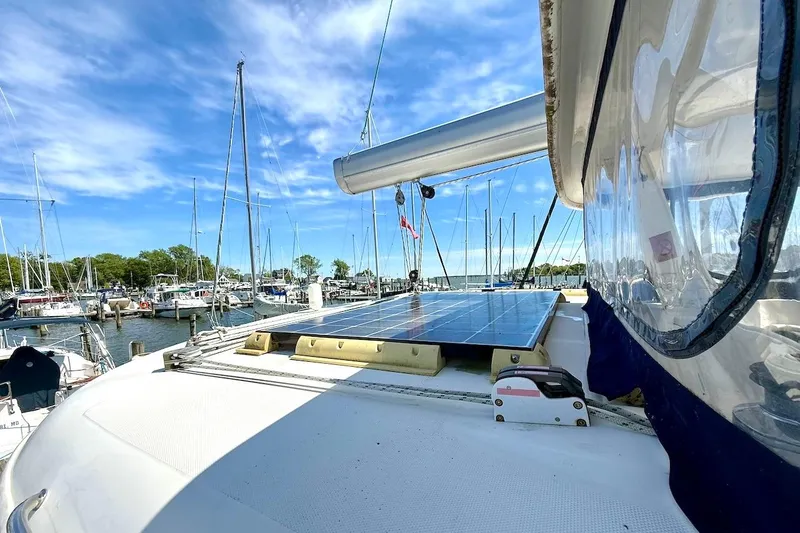 Slide: The Image of Sailboat Leopard 46 (2010) with solar panels docked in a marina under blue skies. - 29