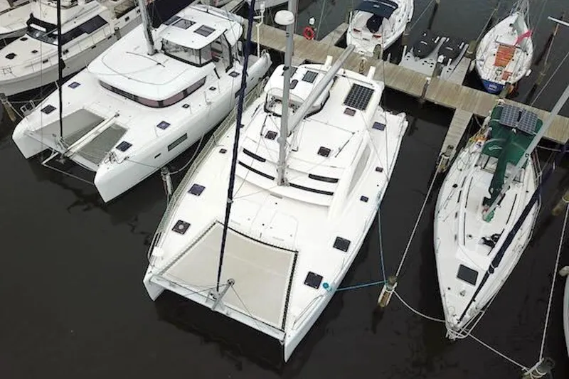 Slide: The Image of Aerial view of a 2010 Leopard 46 catamaran docked among other boats. - 3