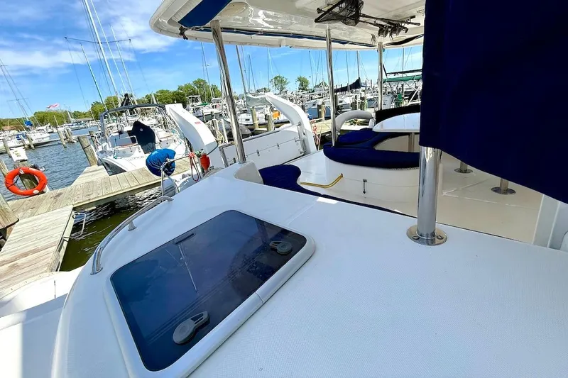 Slide: The Image of Leopard 46 yacht docked at marina, showcasing deck and seating area, 2010 model. - 31