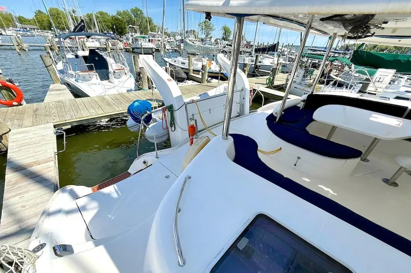 Slide: The Image of Leopard 46 catamaran docked at marina, featuring spacious deck and seating, 2010 model. - 32