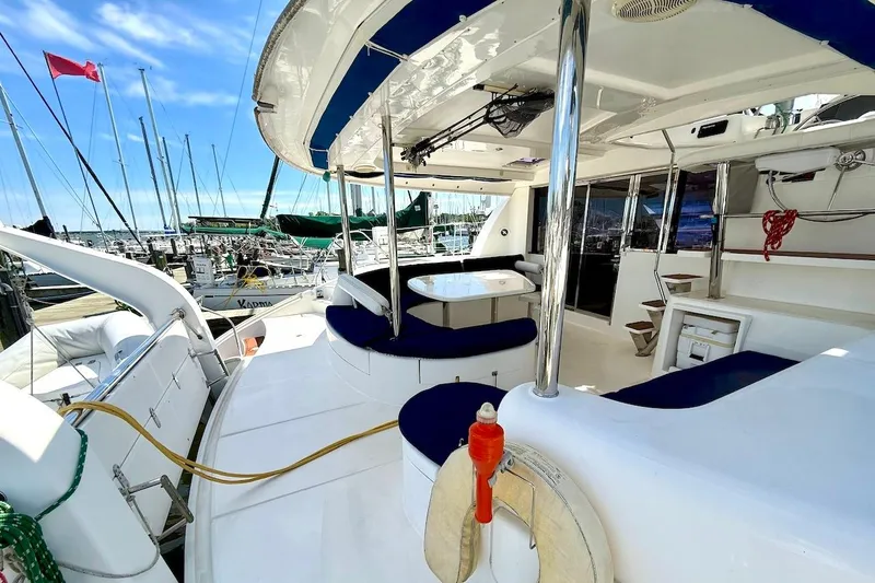 Slide: The Image of Luxurious 2010 Leopard 46 yacht interior with seating, docked at marina under clear blue sky. - 34