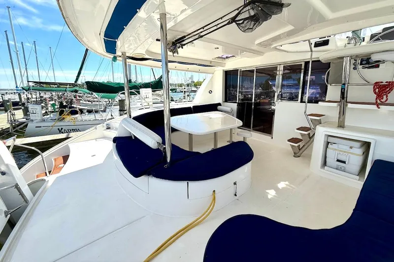 Slide: The Image of Spacious deck of 2010 Leopard 46 yacht with seating and table, docked at marina. - 35