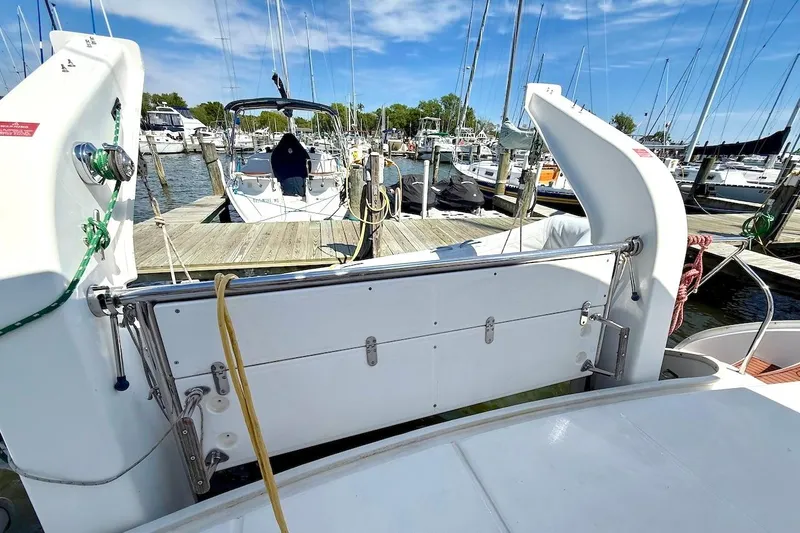 Slide: The Image of Leopard 46 catamaran docked at marina, showcasing rear deck and surrounding boats. - 37