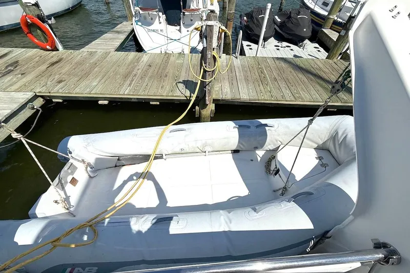 Slide: The Image of Inflatable dinghy docked beside a Leopard 46 yacht, 2010 model, at a marina. - 38