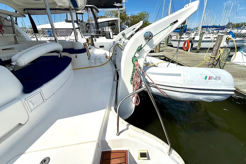 Slide: The Image of Leopard 46 yacht from 2010 docked with inflatable boat, featuring spacious deck and seating. - 42