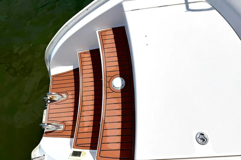 Slide: The Image of Sleek Leopard 46 yacht deck with wooden steps, 2010 model, on calm water. - 44