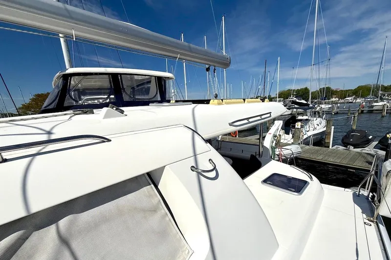 Slide: The Image of 2010 Leopard 46 catamaran docked at marina under clear blue sky. - 46