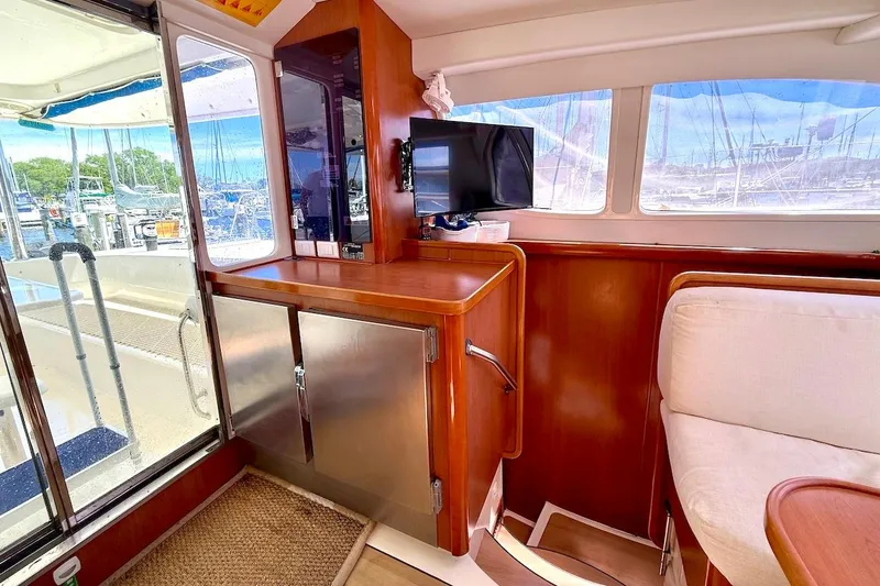 Slide: The Image of Interior of 2010 Leopard 46 yacht with wood cabinetry and marina view. - 50
