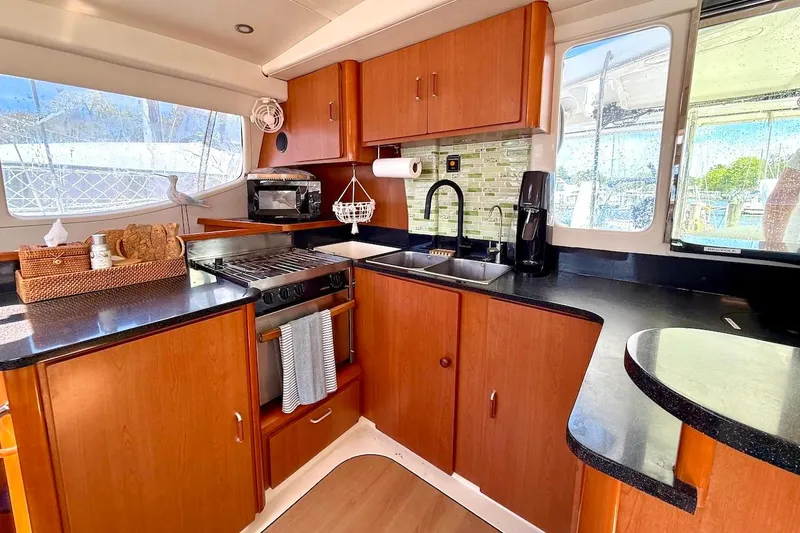 Slide: The Image of Luxurious kitchen interior of 2010 Leopard 46 yacht with modern appliances and wood cabinetry. - 51