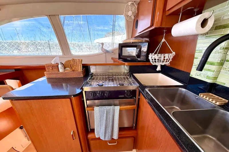 Slide: The Image of Luxurious kitchen interior of 2010 Leopard 46 yacht with modern amenities and scenic window view. - 52