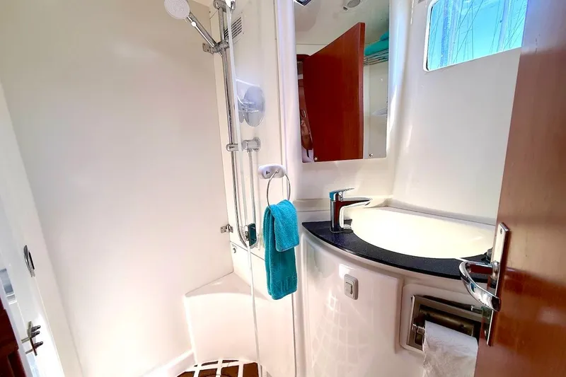 Slide: The Image of Bathroom interior of a 2010 Leopard 46 yacht, featuring a shower and sink. - 59