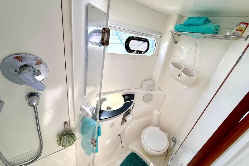 Slide: The Image of Compact yacht bathroom with shower, sink, and toilet in a 2010 Leopard 46 model. - 60