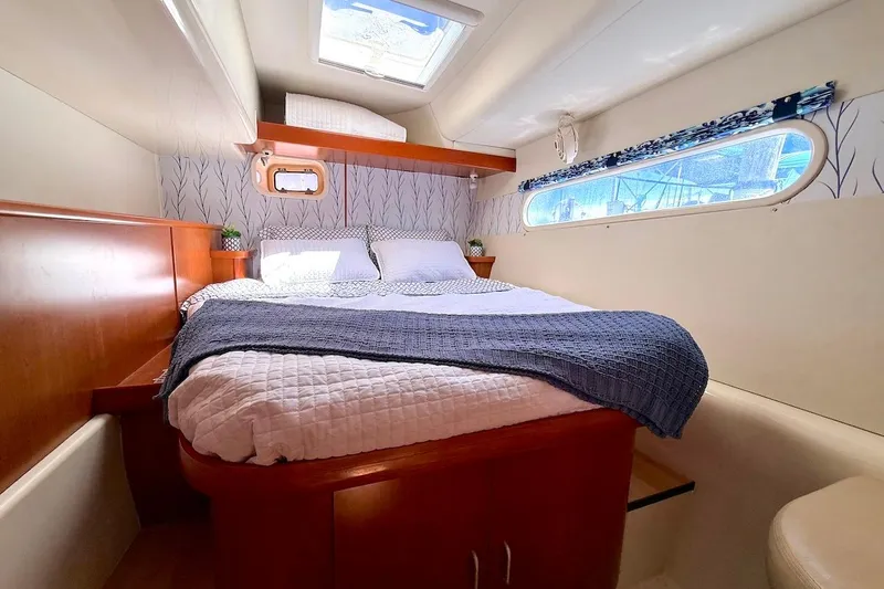 Slide: The Image of Luxurious cabin interior of a 2010 Leopard 46 yacht with cozy bedding. - 63