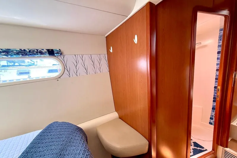 Slide: The Image of Interior of 2010 Leopard 46 yacht cabin with wooden paneling and bathroom view. - 64