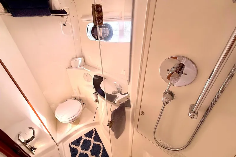Slide: The Image of Compact yacht bathroom with shower, toilet, and sink in a 2010 Leopard 46 model. - 66