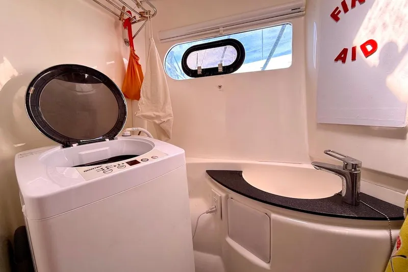 Slide: The Image of Laundry area in a 2010 Leopard 46 yacht with washing machine and sink. - 69