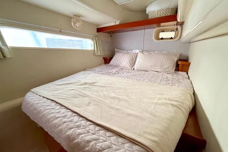 Slide: The Image of Cozy bedroom in 2010 Leopard 46 yacht with plush bedding and natural light. - 70