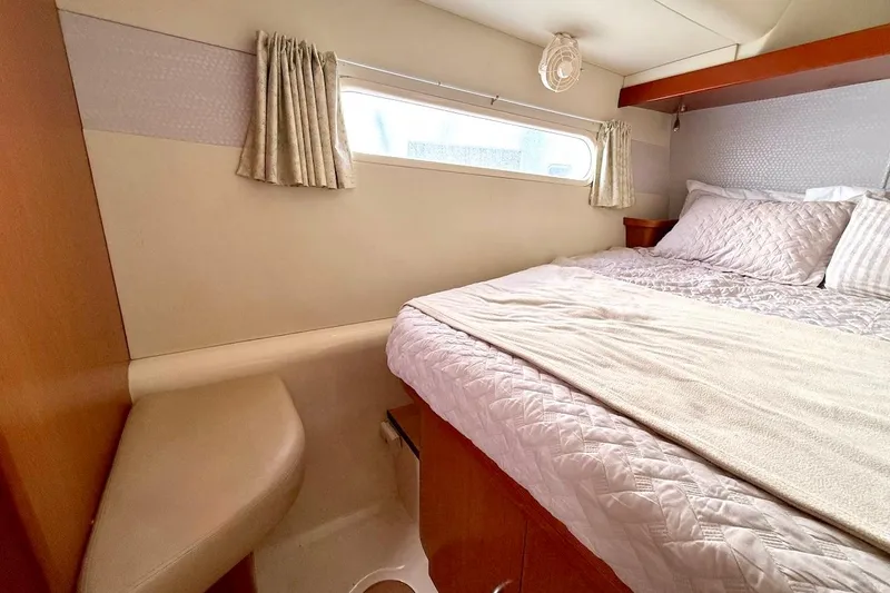 Slide: The Image of Cozy bedroom interior of 2010 Leopard 46 yacht with window and bedding. - 71