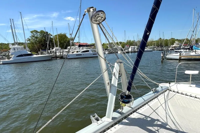 Slide: The Image of Sailboat deck view at marina, featuring Leopard 46 model, 2010, with moored yachts in background. - 9