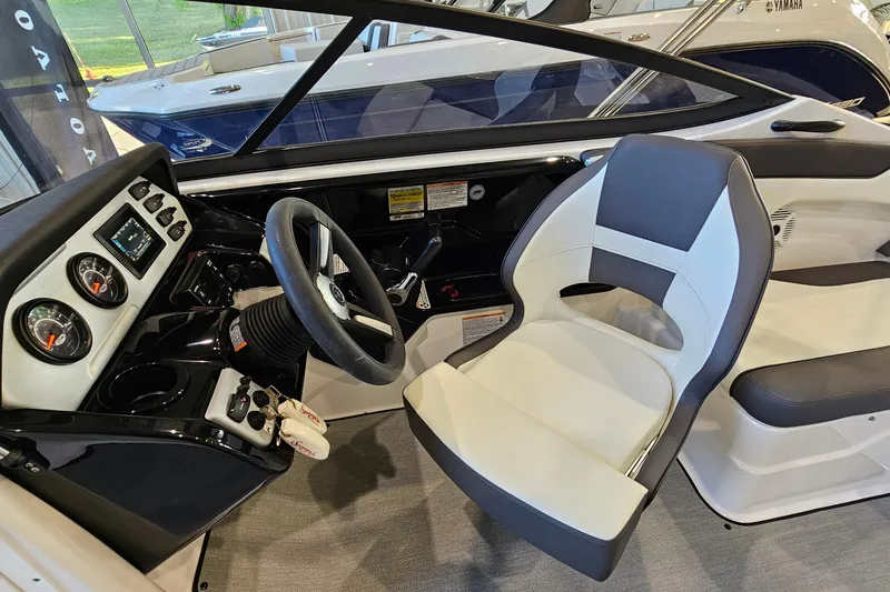 Slide: The Image of 2022 Yamaha Boats SX210 cockpit with steering wheel and dashboard controls. - 10
