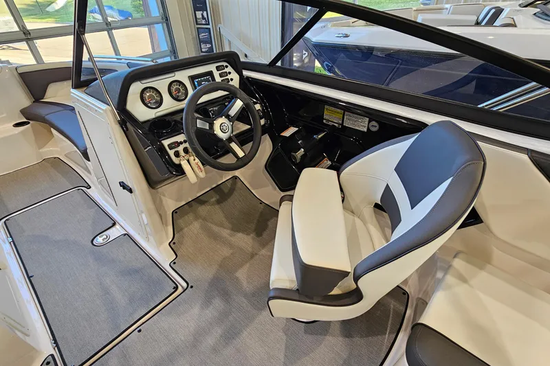 Slide: The Image of 2022 Yamaha Boats SX210 cockpit with steering wheel, gauges, and comfortable seating. - 11