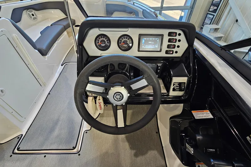 Slide: The Image of 2022 Yamaha Boats SX210 dashboard with steering wheel and control panel. - 12